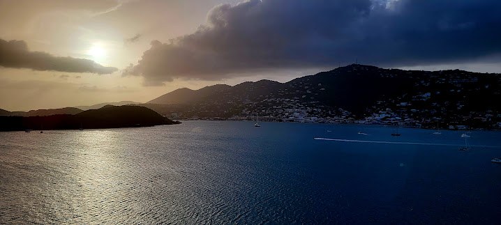 Sunset over Tortola from the cruise ship, with the hills going to silhouette against the last light.