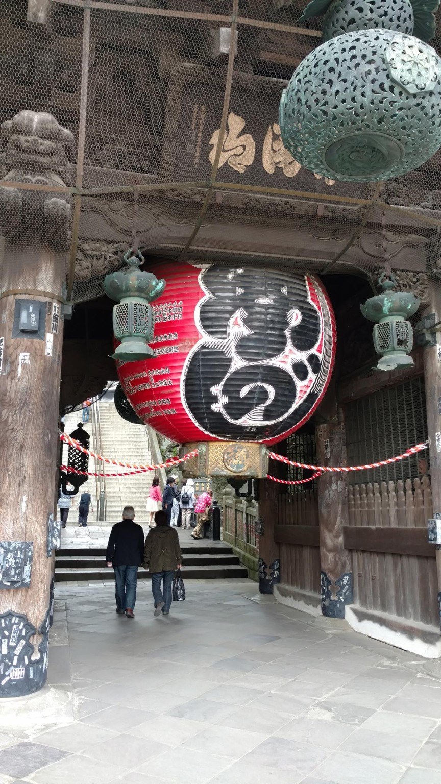 A large temple lantern and gate near the approach to Naritasan Shinshoji Temple