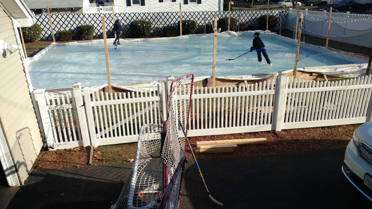 Larger backyard rink in a snowy yard