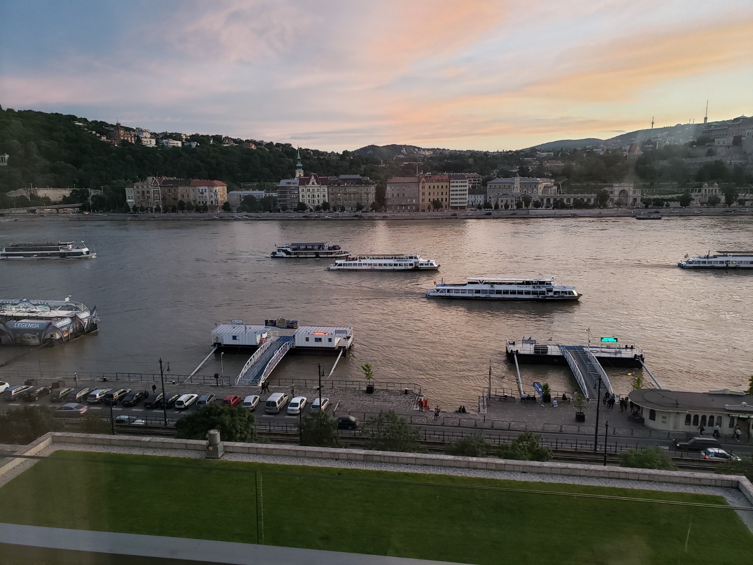 Evening over the Danube with riverboats moving between Buda and Pest