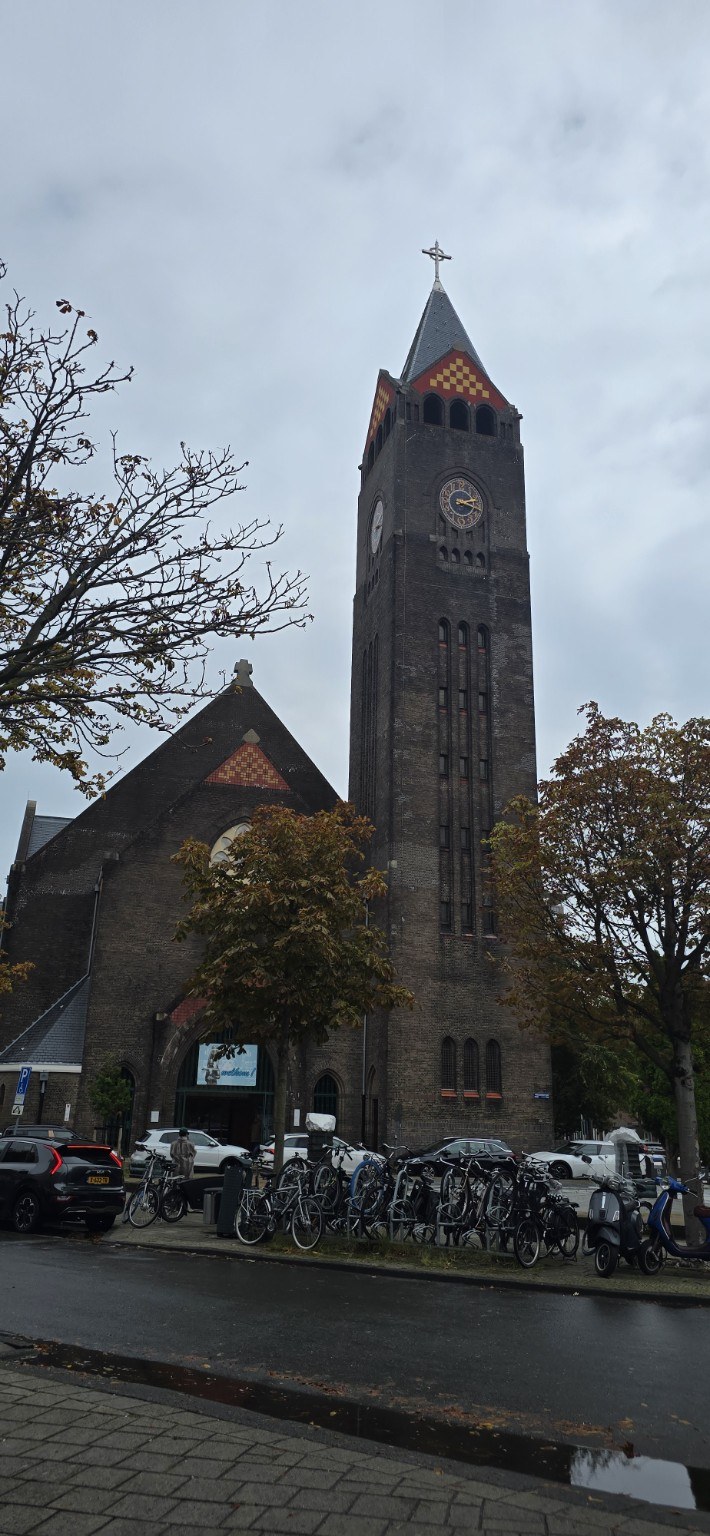 Amsterdam neighborhood church with bicycles in front