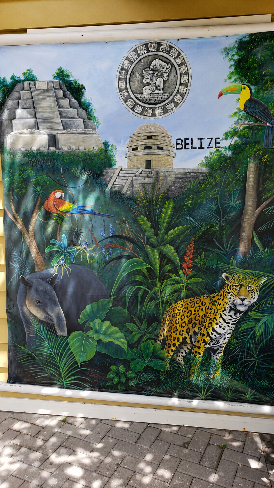 Belize mural showing Mayan temples, jaguars, and tropical birds