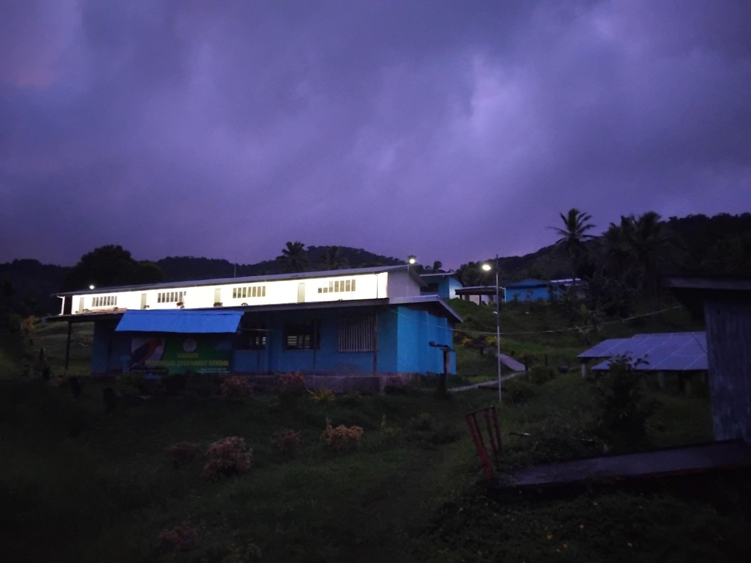School building glowing at dusk thanks to solar power