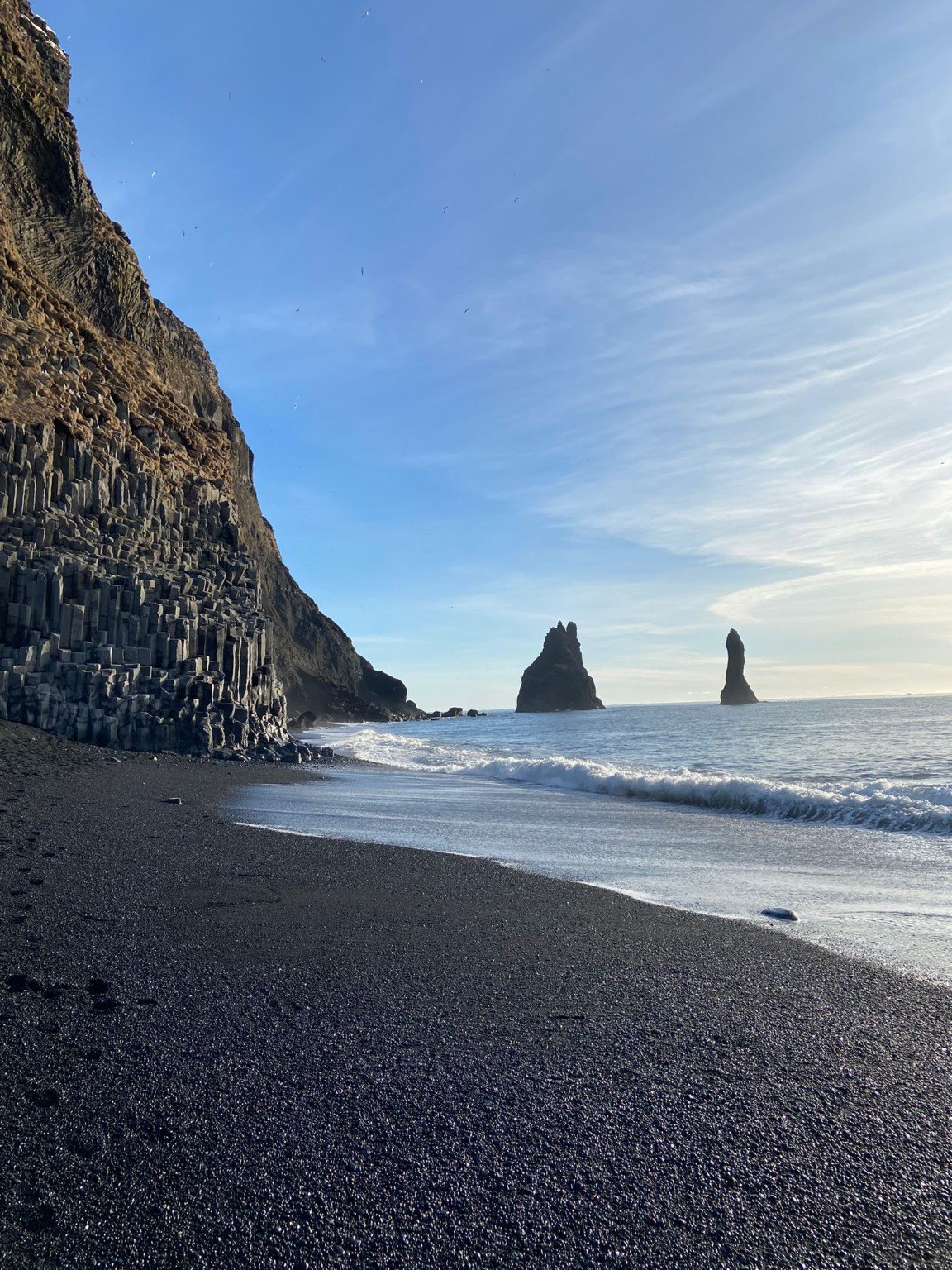 Reynisfjara black sand beach, basalt columns, and sea stacks near Vík