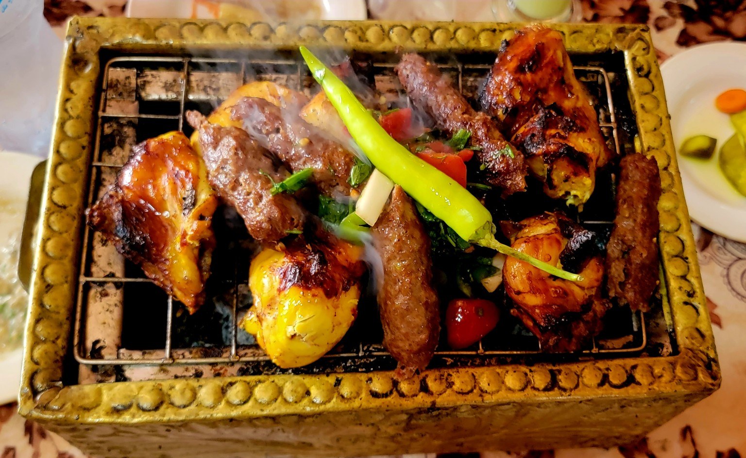 Egyptian grilled meats and mezze spread on a restaurant table
