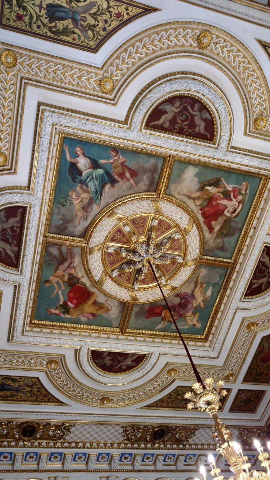 An ornate palace or civic interior ceiling with gilded detail