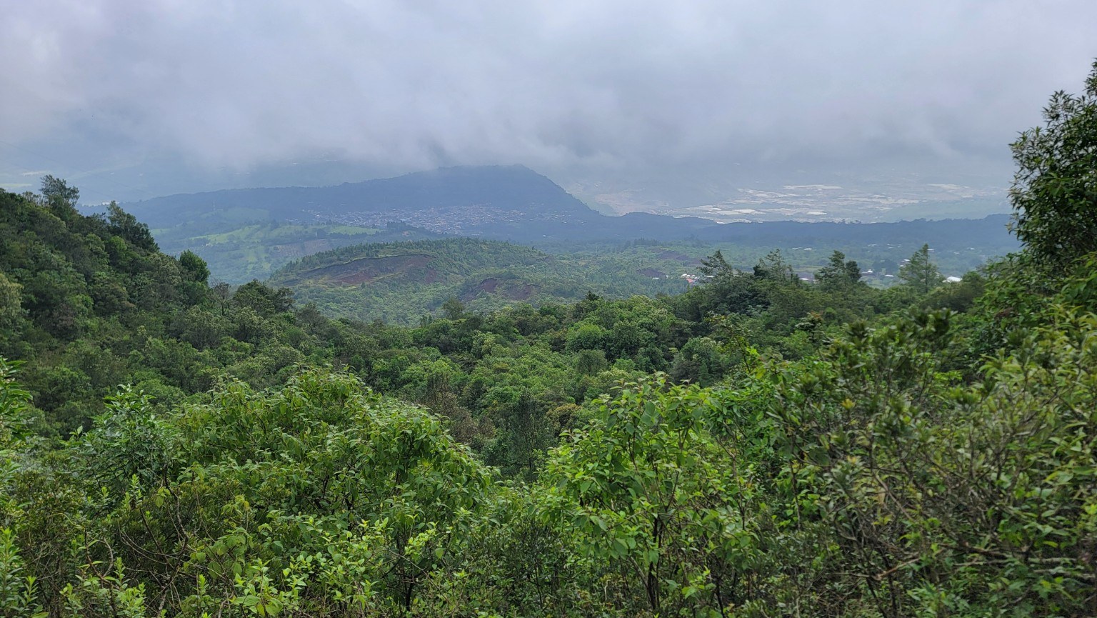 Misty Guatemalan highlands and valley seen from the Pacaya trail